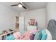 Cozy bedroom with a ceiling fan, a white dresser and decorative pillows at 3610 Central Park Dr, Loganville, GA 30052