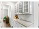 Butler's pantry with white cabinets, granite countertops, and stylish decor at 3610 Central Park Dr, Loganville, GA 30052