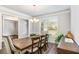 Elegant dining room with large windows, crown molding, and stylish furnishings at 3610 Central Park Dr, Loganville, GA 30052