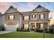 Brick two-story home with an attached two car garage and manicured front lawn at 3610 Central Park Dr, Loganville, GA 30052