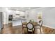 Open kitchen with granite countertops, stainless appliances, and dining area with backyard access at 3610 Central Park Dr, Loganville, GA 30052