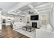 Open-concept living room with a fireplace, hardwood floors and kitchen view at 3610 Central Park Dr, Loganville, GA 30052