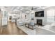 Spacious open-concept living room with hardwood floors, fireplace, and connection to the kitchen at 3610 Central Park Dr, Loganville, GA 30052