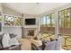 Relaxing screened-in porch with fireplace, cozy seating, and outdoor view at 3610 Central Park Dr, Loganville, GA 30052
