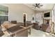 Spacious screened-in porch featuring fireplace, outdoor seating, dining table, and ceiling fan at 3610 Central Park Dr, Loganville, GA 30052