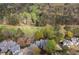An aerial view captures the property surrounded by a mature tree canopy, overlooking the community golf course at 8207 Fairview Blf, Alpharetta, GA 30022