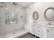 Bathroom featuring double vanity, step-in shower, and a view from the window at 8207 Fairview Blf, Alpharetta, GA 30022