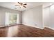 Spacious bedroom with natural light and hardwood floors, offering a comfortable and inviting atmosphere at 8207 Fairview Blf, Alpharetta, GA 30022