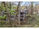 Exterior view of the home through the trees at 8207 Fairview Blf, Alpharetta, GA 30022