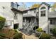 View of townhouse with multiple stories, gray siding, and stairs leading to front entrance at 8207 Fairview Blf, Alpharetta, GA 30022