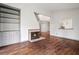 Spacious living room featuring built-in shelving, a fireplace, and hardwood floors throughout at 8207 Fairview Blf, Alpharetta, GA 30022