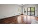 Bright living room featuring hardwood floors and sliding glass doors with a view of the outdoor scenery at 8207 Fairview Blf, Alpharetta, GA 30022