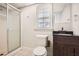 Bathroom featuring a shower, neutral wall, and wood vanity at 1105 S Parkwood Dr, Forest Park, GA 30297