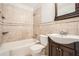 Well-lit bathroom featuring a tub and shower combination and a dark wood vanity at 1105 S Parkwood Dr, Forest Park, GA 30297