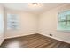 Bedroom with neutral walls, dark floors, and bright natural light at 1105 S Parkwood Dr, Forest Park, GA 30297