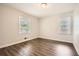 Bedroom with neutral walls, wood-look floors, and bright windows at 1105 S Parkwood Dr, Forest Park, GA 30297
