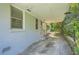 Open carport area featuring a painted brick exterior wall and an attached walkway at 1105 S Parkwood Dr, Forest Park, GA 30297