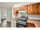 Efficient kitchen space with wooden cabinets and modern appliances at 1105 S Parkwood Dr, Forest Park, GA 30297