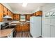 Classic kitchen featuring wooden cabinets, stainless-steel appliances, and vinyl flooring at 1105 S Parkwood Dr, Forest Park, GA 30297