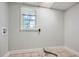 Functional laundry room featuring tiled floors, a window, and clean, neutral-toned walls at 1105 S Parkwood Dr, Forest Park, GA 30297
