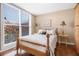 Bright bedroom features large windows with views, wood floors, and two side tables at 1133 Church St # 1, Covington, GA 30014