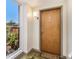 Condo entryway with a wooden front door, welcome mat, and natural light from a nearby window at 1133 Church St # 1, Covington, GA 30014