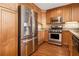 Modern kitchen featuring stainless steel appliances, wood cabinets, and hardwood floors at 1133 Church St # 1, Covington, GA 30014