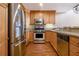 Well-equipped kitchen featuring stainless steel appliances, wood cabinets, and hardwood floors at 1133 Church St # 1, Covington, GA 30014