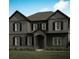 Charming two-story home featuring a well-manicured lawn, gray siding, and classic black shutters at 2740 Byess Ct, Marietta, GA 30064