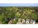 Aerial view of the homes in the neighborhood surrounded by lush green trees and the distant city skyline at 3100 Queens Ne Walk, Atlanta, GA 30345