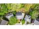 An aerial view of a home showcasing its backyard, mature trees, deck, patio, and well-defined property lines at 3100 Queens Ne Walk, Atlanta, GA 30345
