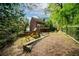 Large backyard with play structure and mature trees at 3100 Queens Ne Walk, Atlanta, GA 30345
