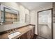 Spacious bathroom featuring a double vanity, granite countertops, and neutral tile flooring at 3100 Queens Ne Walk, Atlanta, GA 30345