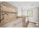 Luxurious bathroom showcasing a glass-enclosed shower, soaking tub, and neutral tile at 3100 Queens Ne Walk, Atlanta, GA 30345
