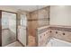 Stunning shower with tiled walls and glass door with a soaking tub and hardwood floors at 3100 Queens Ne Walk, Atlanta, GA 30345