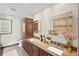 Bright bathroom with a double vanity, granite countertops, a large mirror, and neutral tile flooring at 3100 Queens Ne Walk, Atlanta, GA 30345
