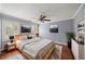 Comfortable bedroom featuring hardwood floors, a ceiling fan, plantation shutters, and neutral paint at 3100 Queens Ne Walk, Atlanta, GA 30345