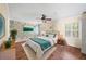 Well-lit bedroom with hardwood floors, plantation shutters, and a ceiling fan at 3100 Queens Ne Walk, Atlanta, GA 30345