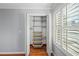 Bedroom closet with metal and wood shelving and organizers provides ample storage space at 3100 Queens Ne Walk, Atlanta, GA 30345
