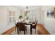 Formal dining room with stylish furnishings, decorative rug, and natural light from shuttered windows at 3100 Queens Ne Walk, Atlanta, GA 30345