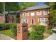 Beautiful two-story brick home with manicured landscaping, charming shutters, and a welcoming entrance at 3100 Queens Ne Walk, Atlanta, GA 30345