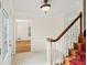 Spacious foyer featuring decorative glass door, hardwood floors, staircase, and trim at 3100 Queens Ne Walk, Atlanta, GA 30345