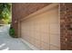 Attached two-car garage with light beige doors and brick siding at 3100 Queens Ne Walk, Atlanta, GA 30345