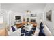 Bright living room with a fireplace, white built-ins, hardwood floors, and comfortable seating area at 3100 Queens Ne Walk, Atlanta, GA 30345