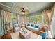 Cozy sunroom with lots of windows and comfortable wicker furniture at 3100 Queens Ne Walk, Atlanta, GA 30345