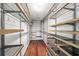 Spacious walk-in closet featuring metal shelving, wooden accents, and hardwood floors, providing ample storage solutions at 3100 Queens Ne Walk, Atlanta, GA 30345
