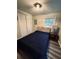 Bedroom with a cozy bed featuring a unique headboard, accompanied by a stylish side table and closet at 5400 Kings Camp Rd, Acworth, GA 30102