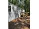 Home exterior featuring wood deck, gray siding, and surrounding trees at 5400 Kings Camp Rd, Acworth, GA 30102