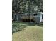 Exterior view of a charming house with a deck, surrounded by lush greenery and a well-maintained lawn at 5400 Kings Camp Rd, Acworth, GA 30102