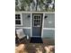 Inviting front porch with a comfortable chair and 'Relax' pillow, creating a peaceful entrance at 5400 Kings Camp Rd, Acworth, GA 30102